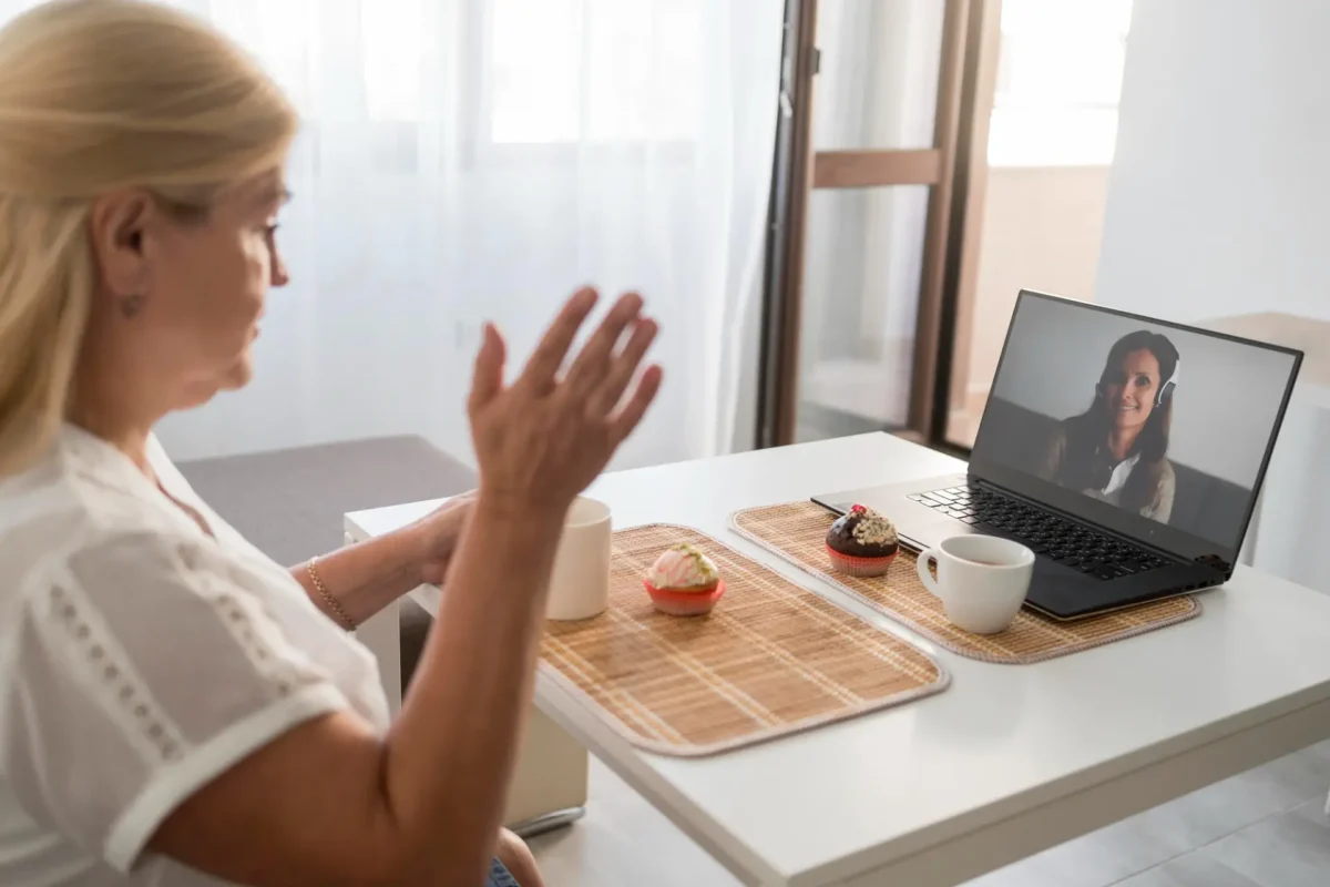 Woman participating in a Zoom hypnosis session for driving-related fear and panic.